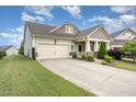 Well-maintained single-Gathering home with a two-car garage and beautifully landscaped front yard at 1528 Anthology Dr, Durham, NC 27703