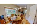 Bright dining area with wood floors and a view to the kitchen features a round wooden table and chairs at 20 Banbury Ct, Roxboro, NC 27573