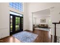 Grand foyer with high ceilings, hardwood floors, and a view into the living room at 2000 Katesbridge Ln, Raleigh, NC 27614