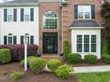 Charming front entrance with well-maintained landscaping and a stylish black front door at 2000 Katesbridge Ln, Raleigh, NC 27614