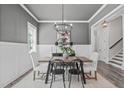 Elegant dining room with modern chandelier, wainscoting, and stylish table setting at 2036 Amy Grace Ct, Fuquay Varina, NC 27526