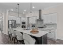 Modern kitchen featuring a large island, stainless steel appliances, and pendant lighting at 2036 Amy Grace Ct, Fuquay Varina, NC 27526