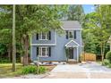 Charming two-story home with blue siding, black shutters, and a well-manicured lawn, creating a welcoming curb appeal at 214 Wax Myrtle Ct, Cary, NC 27513