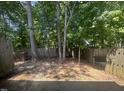 Wood-fenced backyard offering privacy surrounded by towering trees, providing a serene outdoor living space at 225 Virens Drive, Cary, NC 27511