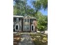 Traditional two-story townhome featuring a mix of siding and brick, complemented by a walkway and verdant landscaping at 225 Virens Drive, Cary, NC 27511