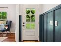 The inviting entryway features wainscoting and a glass-paneled front door at 2409 New Hope Church Rd, Chapel Hill, NC 27514