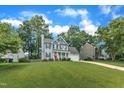 Attractive two-story home with a well-maintained lawn in a lush, green neighborhood at 2721 Dahlgreen Rd, Raleigh, NC 27615