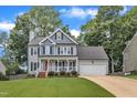 Charming two-story home with a well-manicured lawn and attached two-car garage at 2721 Dahlgreen Rd, Raleigh, NC 27615