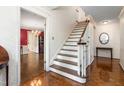 A staircase with hardwood steps and ornate trim in a traditional-style foyer at 3123 Amherst Ave, Burlington, NC 27215
