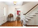 Welcoming foyer featuring hardwood floors, a staircase and decorative wallpaper at 3123 Amherst Ave, Burlington, NC 27215