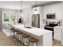 Modern kitchen with stainless steel appliances, a large island, and an adjacent dining area at 336 Cottage Hill Way, Raleigh, NC 27604