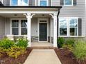 Close-up of the home's inviting front porch, highlighted by stone accents and charming seating area at 3625 Bailey Lake Dr, Fuquay Varina, NC 27526