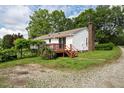Backyard view with a small deck and gravel area at 3627 Nc 57, Hillsborough, NC 27278