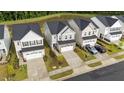 An aerial view of the homes with a nearby pond at 380 Garden Vine Trl, Raleigh, NC 27610
