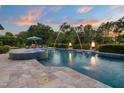 Outdoor swimming pool features water fountains, nearby fire pits, and an umbrella-covered lounge area with seating at 3829 Westbury Lake Dr, Raleigh, NC 27603
