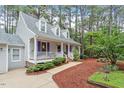 Inviting home exterior featuring a classic porch and lush landscaping at 4953 Tuckahoe Trce, Wake Forest, NC 27587
