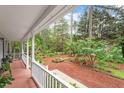 Relaxing porch view overlooking a beautifully landscaped yard with mature trees at 4953 Tuckahoe Trce, Wake Forest, NC 27587