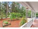 Cozy front porch with views of a serene front yard with mature trees at 4953 Tuckahoe Trce, Wake Forest, NC 27587