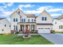 Beautiful two-story home with a well-manicured lawn, two-car garage, and brick and white siding exterior at 508 White Oak Branch Ln, Apex, NC 27523