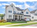 Beautiful two-story home with manicured lawn, brick accents, and a charming front garden at 508 White Oak Branch Ln, Apex, NC 27523