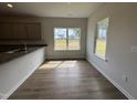Dining area filled with natural light, wood floors, and granite countertops creating a warm inviting space at 51 Commons Cir, Clayton, NC 27520