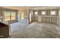 Spacious living room featuring multiple windows for ample natural light and bare drywall at 51 Commons Cir, Clayton, NC 27520
