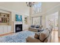 Bright living room features a fireplace, built-in shelves, and tall windows at 5102 Highcroft Dr, Cary, NC 27519
