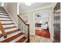 Welcoming foyer boasts wood and tile floors, a staircase, and an entrance into the living room at 5409 Knollwood Rd Rd, Raleigh, NC 27609