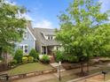 Beautiful home exterior featuring mature trees, lush lawn, and a well-maintained yard at 5644 Wade Park Blvd, Raleigh, NC 27607