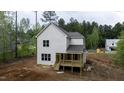 Back exterior view featuring a newly-built home with a rear deck and ample yard space at 60 Purslane Dr, Franklinton, NC 27525
