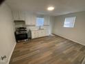 Modern kitchen features white cabinets, new appliances, and wood-look flooring at 609 N Magnolia Ave, Dunn, NC 28334