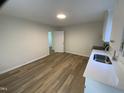 Bright, airy kitchen with modern wood-look flooring and ample countertop space at 609 N Magnolia Ave, Dunn, NC 28334