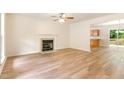 Spacious living room with fireplace, hardwood floors, and natural light at 6321 Lymington Dr, Raleigh, NC 27616