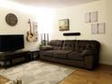 Cozy living room with a comfortable couch, guitar, and mounted TV at 7 Shepherd Ln # Bldg D, Chapel Hill, NC 27514