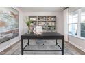 Bright office space featuring built-in shelving, a large desk, and natural light at 7384 Michelle Rd, Rocky Mount, NC 27803