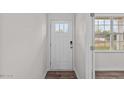 Bright entryway with a glass-paneled front door and wood-look floors at 7439 Michelle Rd, Rocky Mount, NC 27803