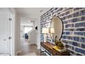 Welcoming entryway with a stylish console table, decorative mirror, and a view of the staircase at 7475 Michelle Rd, Rocky Mount, NC 27803