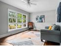 Bright living room with hardwood floors, ceiling fan and a large window with natural light at 829 Burton St, Rocky Mount, NC 27803