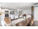 Bright, open-concept living spaces featuring a modern kitchen, dining area, and a comfortable living room at 8615 Kenridge Ln, Fuquay Varina, NC 27526