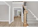 Bright foyer featuring new floors, a staircase with wood and iron accents, and an open floor plan at 1003 Wicksteed Ct, Apex, NC 27502