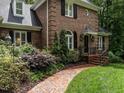 Beautiful brick home exterior with manicured landscaping and welcoming entrance at 104 Deer Park Ln, Cary, NC 27518