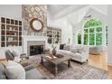 Spacious living room with stone fireplace, built-ins, hardwood floors and lots of light at 10405 Veasey Mill Rd, Raleigh, NC 27615