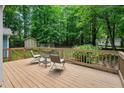 Cozy backyard deck with seating, perfect for relaxing and enjoying the serene wooded surroundings at 10816 Bent Branch Dr, Raleigh, NC 27603
