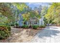 Charming home with blue siding, white trim, landscaped yard, and a gravel driveway at 10816 Bent Branch Dr, Raleigh, NC 27603