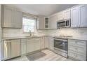 Bright kitchen with subway tile backsplash, stainless steel appliances, and grey cabinets at 10816 Bent Branch Dr, Raleigh, NC 27603