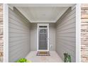 A cozy front entryway adorned with a decorative mat and framed by stone and neutral siding at 1156 Craigmeade Dr, Morrisville, NC 27560