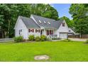 Attractive white home with red shutters, lush green lawn, and well-maintained landscaping at 119 Valleycastle Ct, Clayton, NC 27520