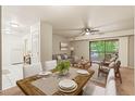 Open floorplan dining and living area with large windows and sliding glass doors to the outside deck at 1200 Schaub Dr # G, Raleigh, NC 27606