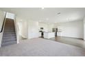 Open concept living area showing stairs, kitchen, living and dining areas at 1205 Solace Way, Rolesville, NC 27571