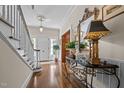 Welcoming foyer featuring hardwood floors, staircase, and stylish console table with decorative accents at 1217 Aycock Ave, Burlington, NC 27215